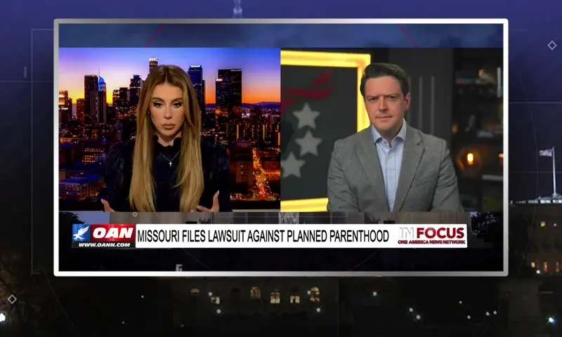 Video still from In Focus on One America News Network showing a split screen of the host on the left side, and on the right side is the guest, Ryan Helfenbein.