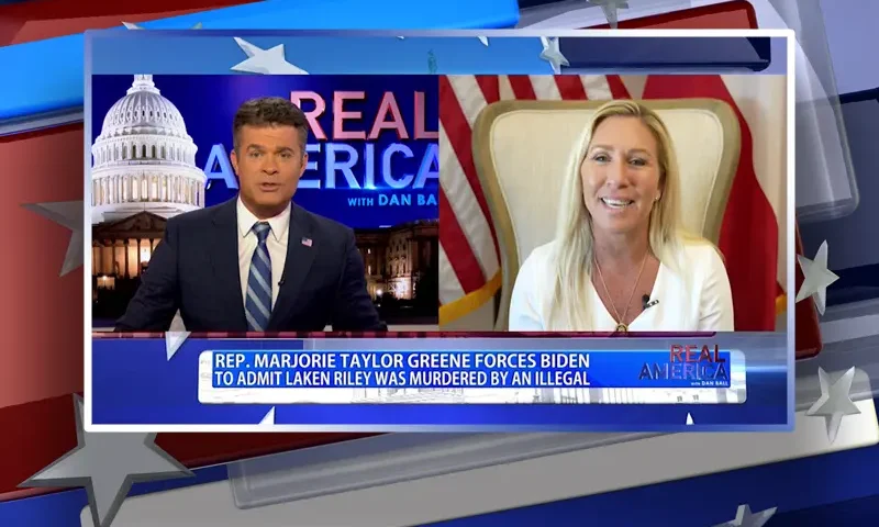 Video still from Real America on One America News Network showing a split screen of the host on the left side, and on the right side is the guest, Rep. Marjorie Taylor Greene.