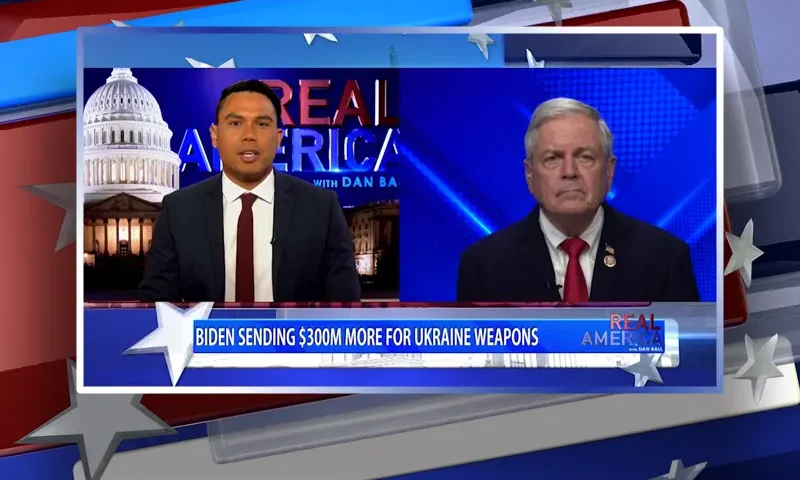 Video still from Real America on One America News Network showing a split screen of the host on the left side, and on the right side is the guest, Ralph Norman.