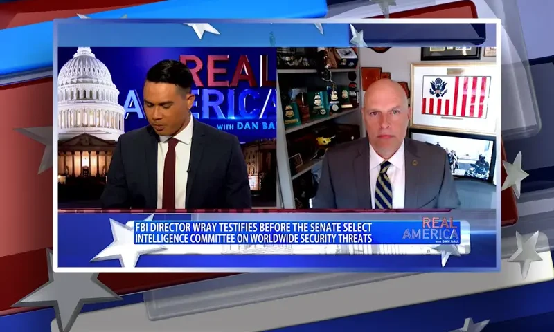 Video still from Real America on One America News Network showing a split screen of the host on the left side, and on the right side is the guest, Ron Vitiello.