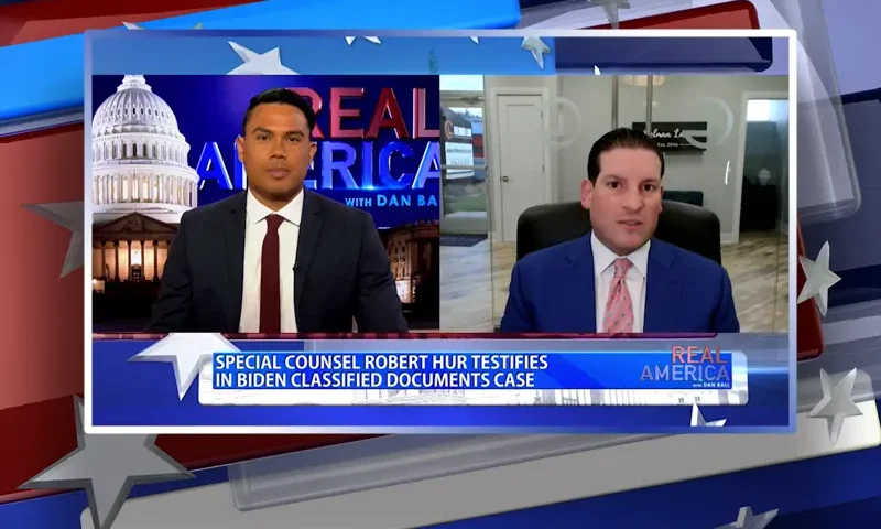 Video still from Real America on One America News Network showing a split screen of the host on the left side, and on the right side is the guest, David Gelman.