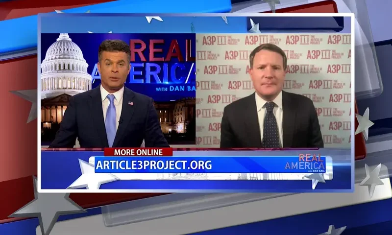 Video still from Real America on One America News Network showing a split screen of the host on the left side, and on the right side is the guest, Mike Davis.