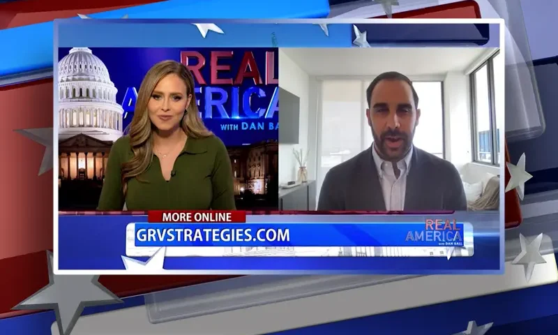 Video still from Real America on One America News Network showing a split screen of the host on the left side, and on the right side is the guest, Garrett Ventry.