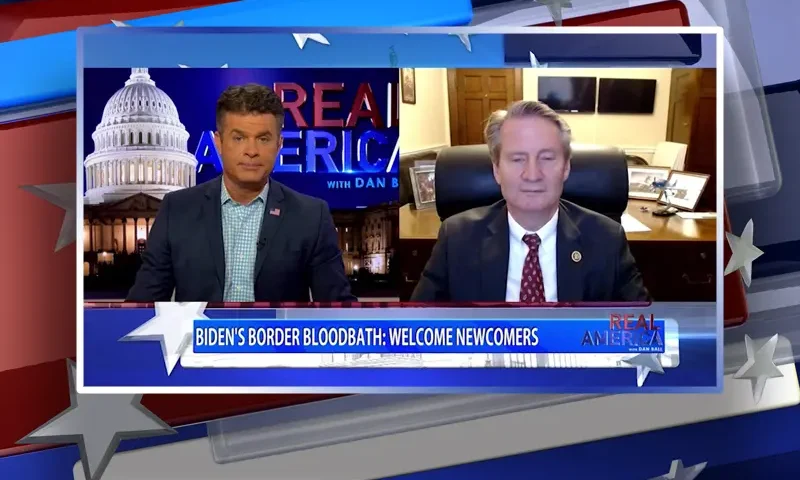 Video still from Real America on One America News Network showing a split screen of the host on the left side, and on the right side is the guest, Rep. Tim Burchett.