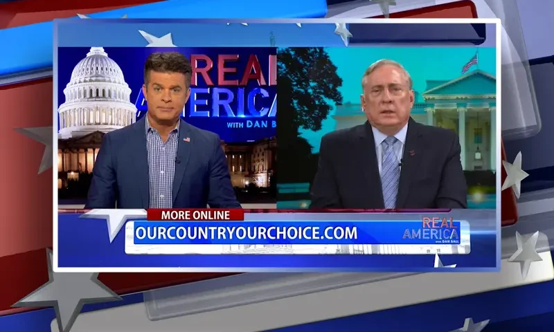 Video still from Real America on One America News Network showing a split screen of the host on the left side, and on the right side is the guest, Col. Doug Macgregor.