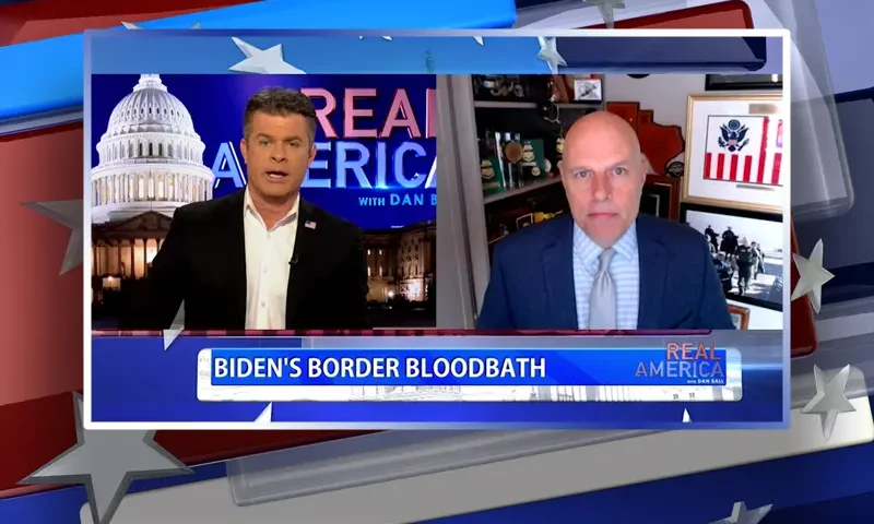 Video still from Real America on One America News Network showing a split screen of the host on the left side, and on the right side is the guest, Ron Vitiello.