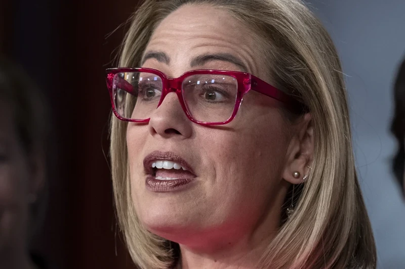 1 of 4 | FILE - Then Sen. Kyrsten Sinema, D-Ariz., speaks to reporters at the Capitol in Washington, Nov. 29, 2022. Independent Sen. Kyrsten Sinema of Arizona has announced that she won't run for a second term. Her decision Tuesday comes after her estrangement from the Democratic Party left her politically homeless and without a clear path to reelection. (AP Photo/J. Scott Applewhite, File)