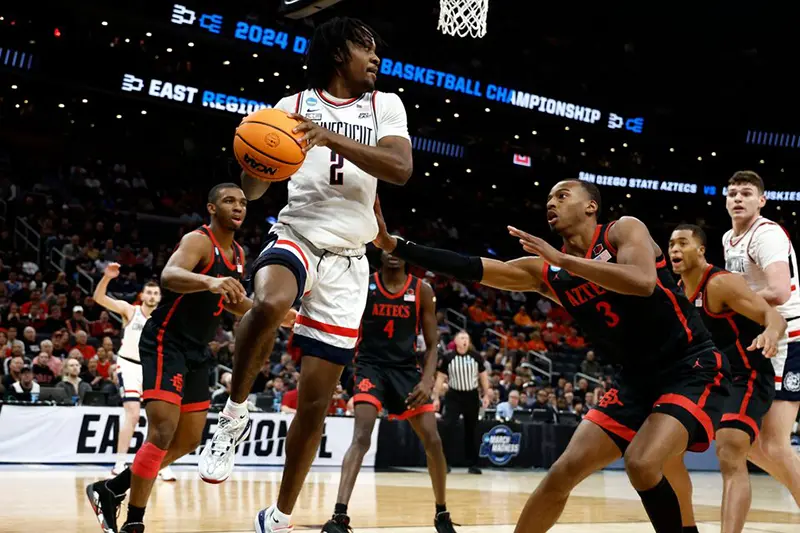 Connecticut Huskies guard Tristen Newton (2) makes a pass against the San Diego State Aztecs in the semifinals of the East Regional of the 2024 NCAA Tournament at TD Garden. Mandatory Credit: Winslow Townson-USA TODAY Sports