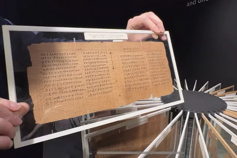 A person shows one of the oldest books in existence, the Crosby-Schoyen Codex, which is expected to fetch over $2.6 million at auction, in New York, U.S., April 2, 2024. REUTERS/Andrew Hofstetter