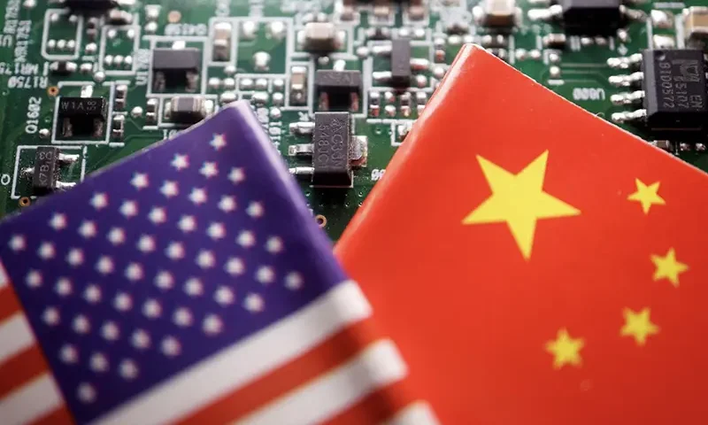 Flags of China and U.S. are displayed on a printed circuit board with semiconductor chips, in this illustration picture taken February 17, 2023. REUTERS/Florence Lo/Illustration/File Photo