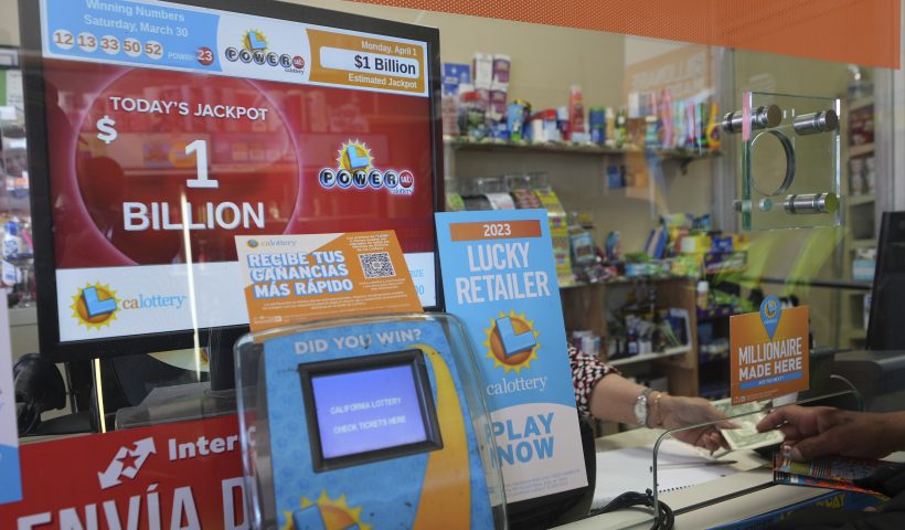Lottery players buy Powerball tickets at the Las Palmitas Mini Market in in the Fashion District downtown Los Angeles on Monday, April 1, 2024. A $1 billion Powerball jackpot will tempt lottery players who think they just might hit it rich after three months without a big winner. No one has won Powerball's jackpot since New Year's Day, a stretch of 38 consecutive drawings without anyone matching the game's six numbers. (AP Photo/Damian Dovarganes)