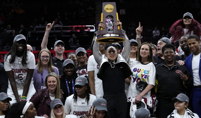 South Carolina head coach Dawn Staley celebrates with her team after the Final Four college basketball championship game against Iowa in the women's NCAA Tournament, Sunday, April 7, 2024, in Cleveland. South Carolina won 87-75. (AP Photo/Carolyn Kaster)