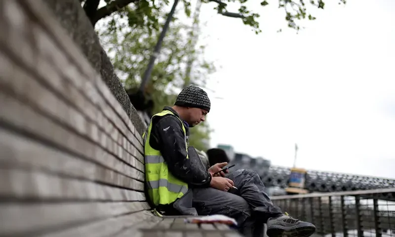 A man checks his phone in the city centre of Dublin, Ireland, May 22, 2018. REUTERS/Max Rossi/File Photo