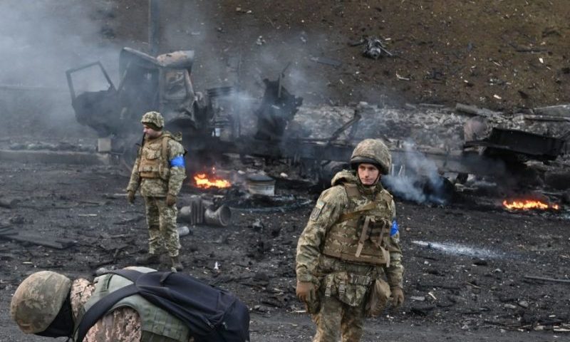 TOPSHOT - Ukrainian service members look for and collect unexploded shells after a fighting with Russian raiding group in the Ukrainian capital of Kyiv in the morning of February 26, 2022, according to Ukrainian service personnel at the scene. - Ukrainian soldiers repulsed a Russian attack in the capital, the military said on February 26 after a defiant President Volodymyr Zelensky vowed his pro-Western country would not be bowed by Moscow. It started the third day since Russian leader Vladimir Putin unleashed a full-scale invasion that has killed dozens of people, forced more than 50,000 to flee Ukraine in just 48 hours and sparked fears of a wider conflict in Europe. (Photo by Sergei SUPINSKY / AFP) (Photo by SERGEI SUPINSKY/AFP via Getty Images)