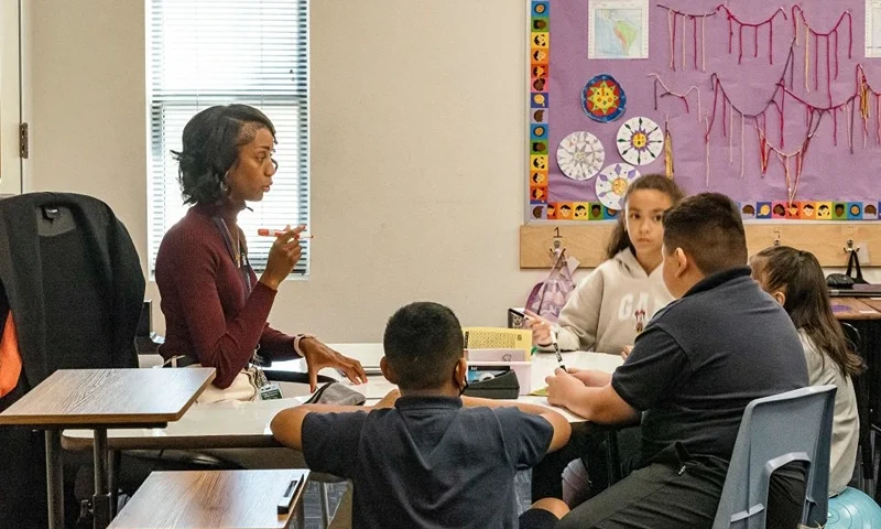 Aisha Thomas (purple shirt) is learning teaching skills with the teacher Alexxa Martinez, in her classroom in Nevitt Elementary School, in Phoenix, Arizona, on October 26, 2022. (Photo by Olivier TOURON / AFP) (Photo by OLIVIER TOURON/AFP via Getty Images)