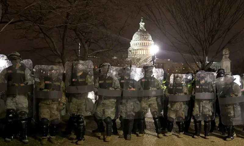 WASHINGTON, DC - JANUARY 06: Members of the National Guard assist police officers line up as they assist police in dispersing protesters who are gathering at the U.S. Capitol Building on January 06, 2021 in Washington, DC. Pro-Trump protesters entered the U.S. Capitol building after mass demonstrations in the nation's capital during a joint session Congress to ratify President-elect Joe Biden's 306-232 Electoral College win over President Donald Trump. (Photo by Tasos Katopodis/Getty Images)