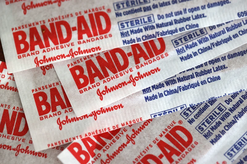 Johnson & Johnson To Split Into Two Publicly Traded Companies
SAN ANSELMO, CALIFORNIA - NOVEMBER 12: In this photo illustration Johnson & Johnson band-aids are displayed on a table on November 12, 2021 in San Anselmo, California. Johnson & Johnson announced plans to split its pharmaceutical and medical devices divisions and consumer products into two publicly traded companies. The company hopes to complete the transaction within two years. (Photo Illustration by Justin Sullivan/Getty Images)