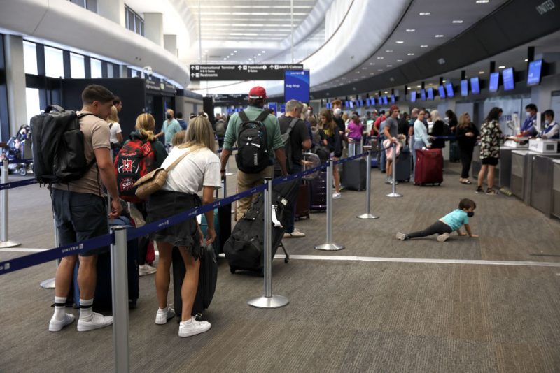 SAN FRANCISCO, CALIFORNIA - JULY 01: Travelers line up to check in for United Airlines flights at San Francisco International Airport on July 01, 2022 in San Francisco, California. According to AAA, nearly 48 million Americans are expected to hit the road for the Fourth of July holiday weekend and will travel more than 50 miles away from their home. It will be the second busiest July 4 travel weekend since 2000. (Photo by Justin Sullivan/Getty Images)