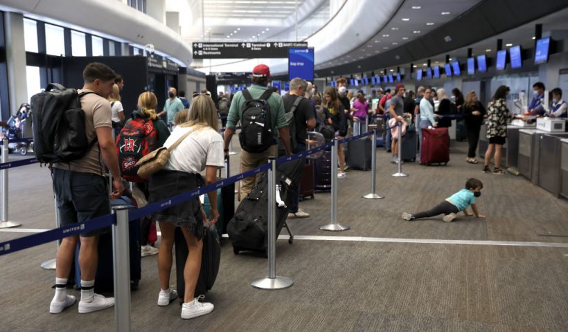 SAN FRANCISCO, CALIFORNIA - JULY 01: Travelers line up to check in for United Airlines flights at San Francisco International Airport on July 01, 2022 in San Francisco, California. According to AAA, nearly 48 million Americans are expected to hit the road for the Fourth of July holiday weekend and will travel more than 50 miles away from their home. It will be the second busiest July 4 travel weekend since 2000. (Photo by Justin Sullivan/Getty Images)