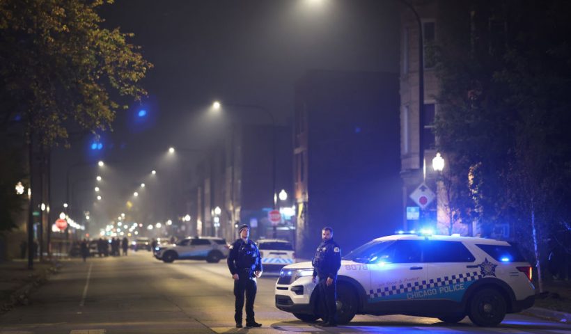 CHICAGO, ILLINOIS - OCTOBER 31: Police investigate the scene where as many as 14 people were reported to have been shot on October 31, 2022 in Chicago, Illinois. Three juveniles were among those reported to have been wounded in the drive-by shooting, according to published reports. (Photo by Scott Olson/Getty Images)