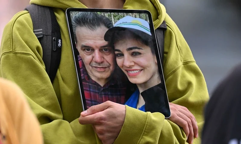 A demonstrator holds a picture of Iranian-German Jamshid Sharmahd (L), who has been sentenced to death in Iran, with his daughter Gazelle Sharmahd during a demonstration for his release in front of the German Foreign Ministry in Berlin on July 31, 2023. Sharmahd was abducted three years ago in late July 2020 by the Iranian authorities and sentenced earlier this year to be hanged for "corruption on earth". Iran's Supreme Court in April confirmed the death penalty. (Photo by INA FASSBENDER / AFP) (Photo by INA FASSBENDER/AFP via Getty Images)