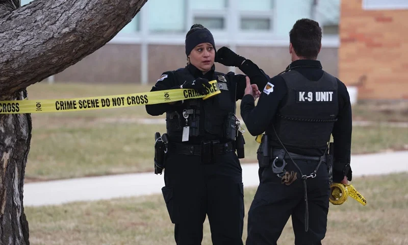 PERRY, IOWA - JANUARY 04: Law enforcement officials put up police tape at the Perry Middle School and High School complex in response to a school shooting on January 04, 2024 in Perry, Iowa. Students were returning to classes today following the holiday break. (Photo by Scott Olson/Getty Images)