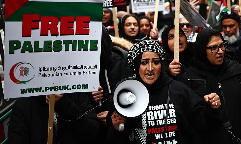 Pro-Palestinian activists and supporters wave flags and carry placards during a National March for Palestine in central London on January 13, 2024. Hamas's unprecedented attack on Israel on October 7, 2023 which left about 1,140 dead in Israel, mostly civilians, according to an AFP tally based on official figures, and saw 250 hostages dragged back into Gaza sparked the war which is still raging in the besieged Gaza Strip. After almost 100 days of war, at least 23,357 people have been killed in the fighting, the majority of them women and children, according to the Hamas health ministry -- or almost one percent of the population. (Photo by HENRY NICHOLLS / AFP) (Photo by HENRY NICHOLLS/AFP via Getty Images)