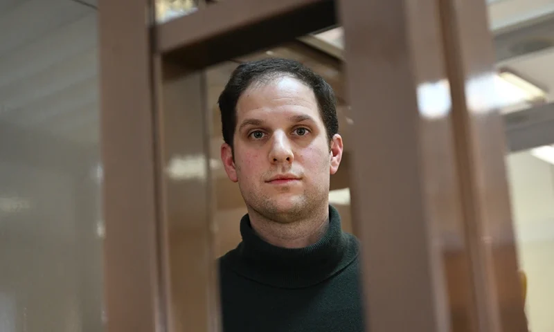 RUSSIA-US-JOURNALIST US journalist Evan Gershkovich, arrested on espionage charges, looks out from inside a defendants' cage before a hearing to consider an appeal on his extended pre-trial detention, at the Moscow City Court in Moscow on February 20, 2024. Wall Street Journal reporter Evan Gershkovich was detained last March on spying charges during a reporting trip to the Urals. (Photo by NATALIA KOLESNIKOVA / AFP) (Photo by NATALIA KOLESNIKOVA/AFP via Getty Images)