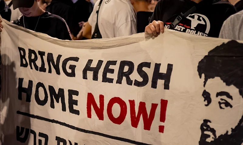 Friends of the kidnapped Hersh Goldberg-Polin hold a sign calling for his return at a demonstration for the kidnapping deal near the Knesset, on March 31, 2024, in Jerusalemm Israel. (Photo by Yahel Gazit / Middle East Images / Middle East Images via AFP) (Photo by YAHEL GAZIT/Middle East Images/AFP via Getty Images)