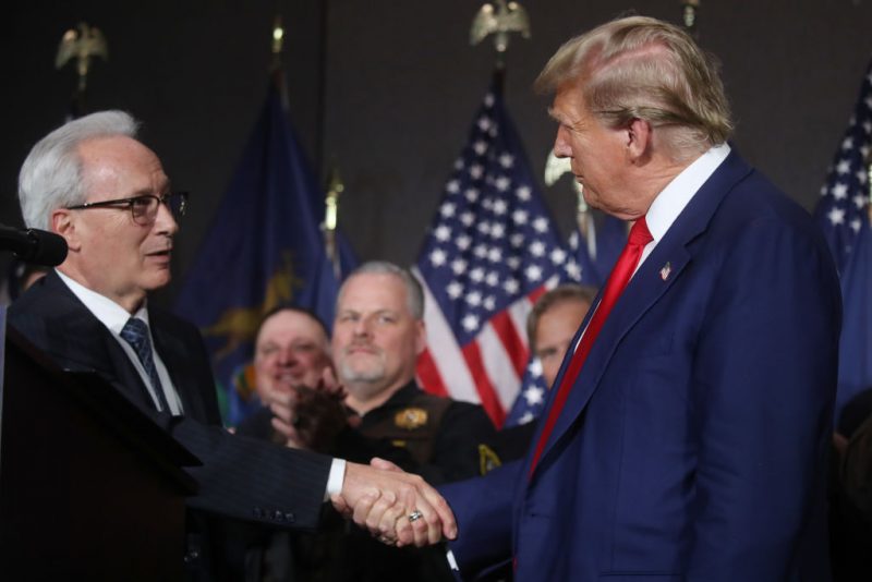 GRAND RAPIDS, MICHIGAN - APRIL 02: Former U.S. President Donald Trump speaks with James Tignanelli, with the Police Officers Association of Michigan as he attends a campaign event on April 02, 2024 in Grand Rapids, Michigan. Trump delivered a speech which his campaign has called "Biden's Border Bloodbath", as recent polls have shown that immigration and the situation at the U.S. Southern border continue to be top issues on voters' minds going into the November election. (Photo by Spencer Platt/Getty Images)