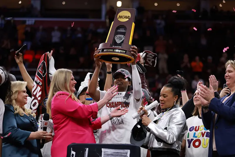CLEVELAND, OHIO - APRIL 07: Sania Feagin #20 of the South Carolina Gamecocks hoists the trophy after beating the Iowa Hawkeyes in the 2024 NCAA Women's Basketball Tournament National Championship at Rocket Mortgage FieldHouse on April 07, 2024 in Cleveland, Ohio. South Carolina beat Iowa 87-75 (Photo by Gregory Shamus/Getty Images)