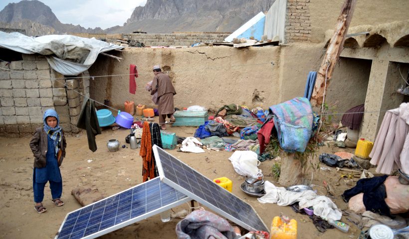 An Afghan man collects his belongings inside the courtyard of his damaged house following heavy rains and flash flooding, in Kandahar on April 14, 2024. At least 33 people have been killed over three days of heavy rains and flash flooding in Afghanistan, the government's disaster management department said on April 14. (Photo by Sanaullah SEIAM / AFP) (Photo by SANAULLAH SEIAM/AFP via Getty Images)