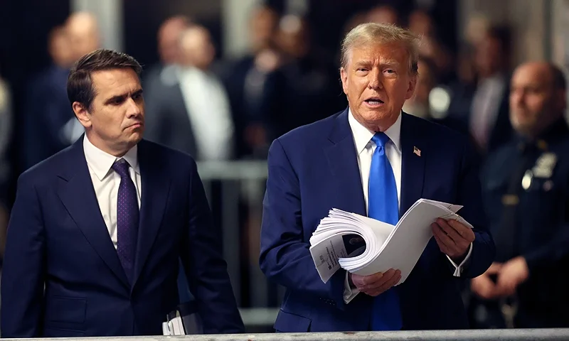 NEW YORK, NEW YORK - APRIL 18: Former US President Donald Trump speaks to the media holding news clippings as he leaves court for the day at Manhattan Criminal Court on April 18, 2024 in New York City. Trump was charged with 34 counts of falsifying business records last year, which prosecutors say was an effort to hide a potential sex scandal, both before and after the 2016 presidential election. Trump is the first former U.S. president to face trial on criminal charges. (Photo by Brendan McDermid-Pool/Getty Images)