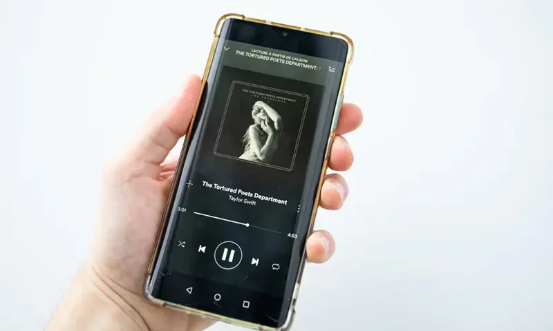 This photograph taken in Paris on April 19, 2024, shows a smatphone displaying the US singer-songwriter Taylor Swift's new album "The Tortured Poets Department" on Spotify. (Photo by Antonin UTZ / AFP) (Photo by ANTONIN UTZ/AFP via Getty Images)