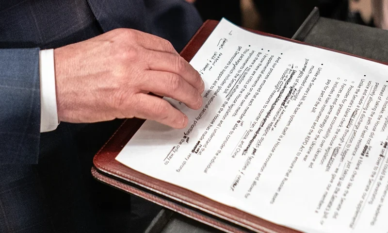 U.S. House Votes On Foreign Aid Package For Ukraine, Israel, And Taiwan WASHINGTON, DC - APRIL 20: Speaker of the House Mike Johnson (R-LA) reads from his notes while speaking with members of the media following passage of a series of foreign aide bills at the U.S. Capitol on April 20, 2024 in Washington, DC. The House is passed a $95 billion foreign aid package today for Ukraine, Israel and Taiwan. (Photo by Nathan Howard/Getty Images)