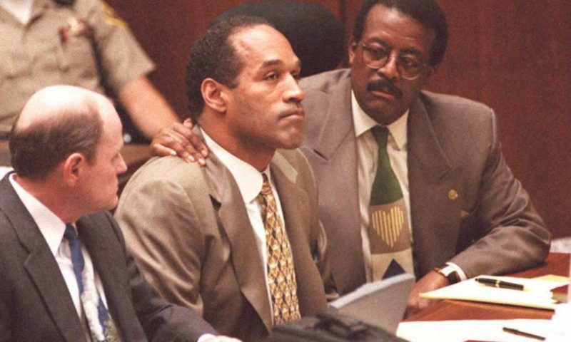 LOS ANGELES, CA - SEPTEMBER 22: Lead defense attorney Johnnie Cochran (R) puts his arm on O.J. Simpson's shoulder after Simpson told Judge Lance Ito 22 September that he has faith that jurors will acquit him of the murder of his ex-wife Nicole Simpson and her friend, Ronald Goldman. At left is defense attorney Robert Blasier. AFP PHOTO (Photo credit should read POO/AFP via Getty Images)