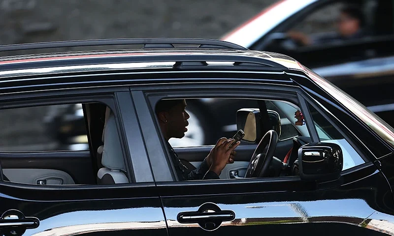 NEW YORK, NY - APRIL 30: A driver uses a phone while behind the wheel of a car on April 30, 2016 in New York City. As accidents involving drivers using phones or other personal devices mount across the country, New York lawmakers have proposed a new test called the Textalyzer to help curb mobile phone usage behind the wheel. Similar to a Breathalyzer test, the Textalyzer would allow police to request phones from drivers involved in accidents and then determine if the phone had been used while the drivers operated their vehicles. The controversial bill is currently in the early committee stage. According to statistics, In 2014 431,000 people were injured and 3,179 were killed in car accidents involving distracted drivers. (Photo by Spencer Platt/Getty Images)