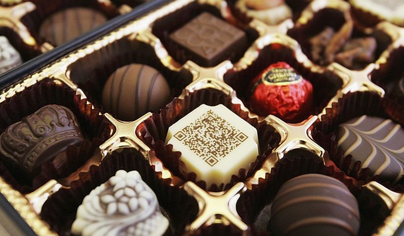 TOKYO, JAPAN - JUNE 29: A box of chocolates contains a piece decorated with a URL written in two-dimensional code on June 29, 2006 in Tokyo, Japan. The chocolate is co-developed by Mary Chocolate Co., Ltd and Nippon Comsys Corporation. Two-dimentional code is widely used in Japan by mobile phone users for reading the URL to access websites. Customers can have their own two-dimensional code or messages written on chocolate for gift-purposes, available at the price of 25,000 yen (US$220) for making the plate and 1050 yen (US$9) for a box of 12 pieces, with a minimum of 500 boxes for an order. (Photo by Junko Kimura/Getty Images)