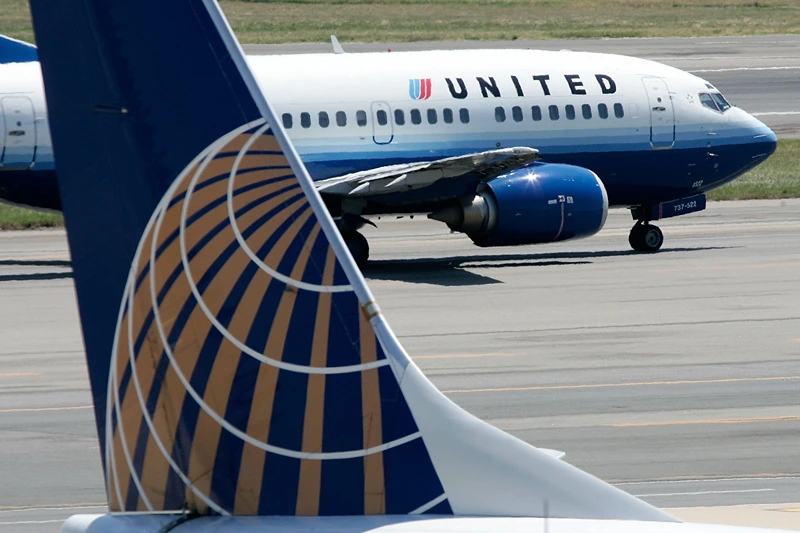 Merger Speculation Rampant Within U.S. Airline Industry
WASHINGTON - AUGUST 16: A United Airlines aircraft passes by a Continental Airlines aircraft as it taxis to takeoff from the runway of Ronald Reagan National Airport August 16, 2006 in Washington, DC. (Photo by Alex Wong/Getty Images)