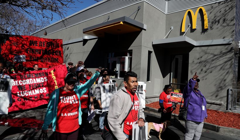 OAKLAND, CA - FEBRUARY 12: Fast food workers and union members carry signs as they stage a protest outside of a McDonald's restaurant on February 12, 2018 in Oakland, California. Dozens of fast food workers staged a protest outside of a McDonald's restaurant to demand a $15 an hour minimum wage on the 50th anniversary of the historic Memphis Sanitation Strike that was led by Dr. Martin Luther King Jr. (Photo by Justin Sullivan/Getty Images)