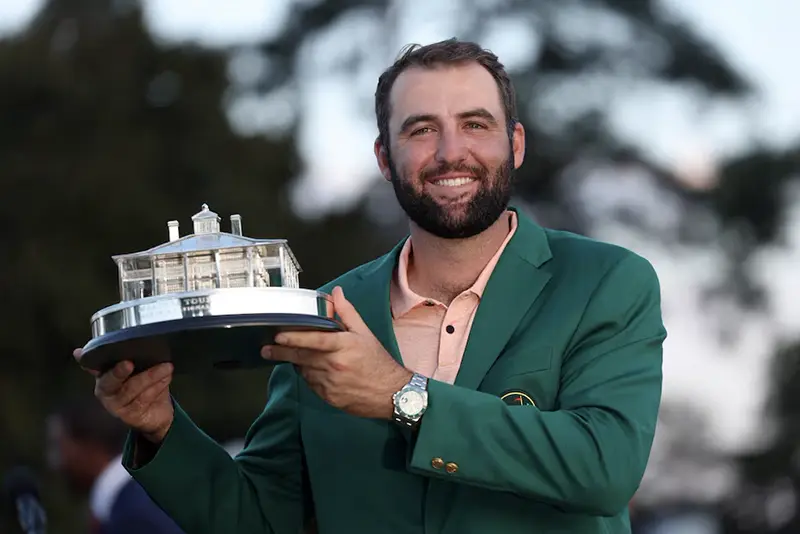 Scottie Scheffler of the U.S. celebrates with his green jacket and the trophy after winning The Masters at Augusta National Golf Club, Augusta, Georgia. REUTERS/Mike Segar
