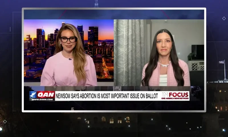 Video still from In Focus on One America News Network showing a split screen of the host on the left side, and on the right side is the guest, Sonja Shaw.