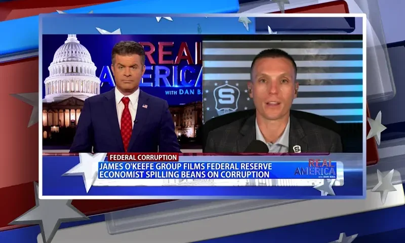 Video still from Real America on One America News Network showing a split screen of the host on the left side, and on the right side is the guest, Steve Friend.