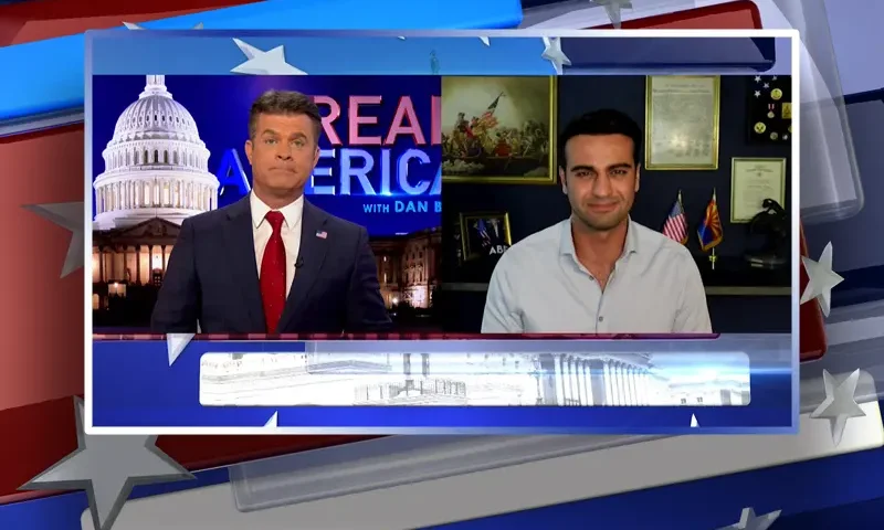 Video still from Real America on One America News Network showing a split screen of the host on the left side, and on the right side is the guest, Abe Hamadeh.
