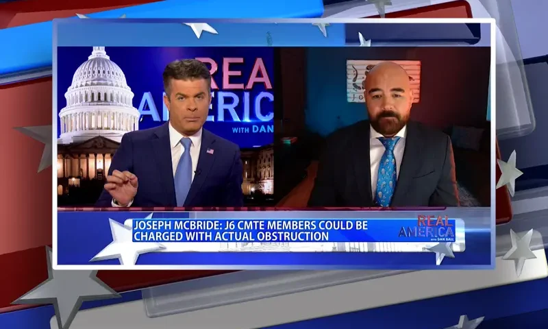 Video still from Real America on One America News Network showing a split screen of the host on the left side, and on the right side is the guest, Joseph McBride.