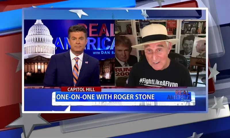 Video still from Real America on One America News Network showing a split screen of the host on the left side, and on the right side is the guest, Roger Stone.
