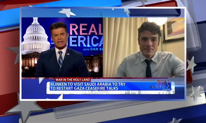 Video still from Real America on One America News Network showing a split screen of the host on the left side, and on the right side is the guest, Joe Kent.