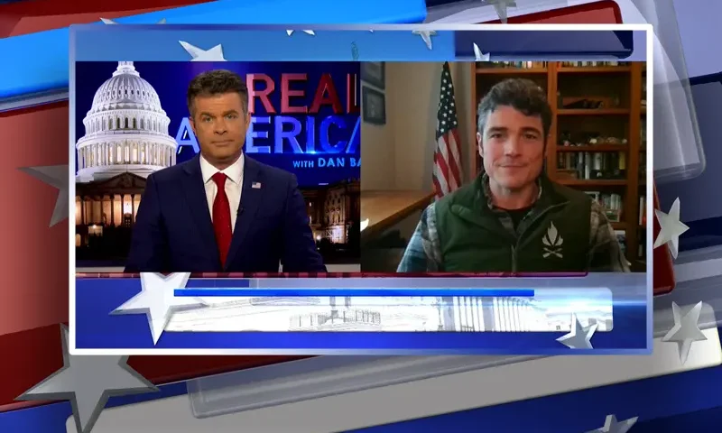 Video still from Real America on One America News Network showing a split screen of the host on the left side, and on the right side is the guest, Joe Kent.