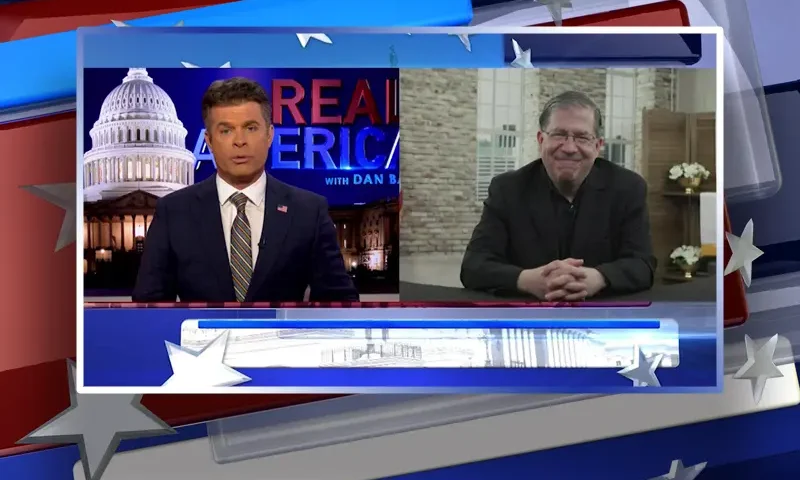 Video still from Real America on One America News Network showing a split screen of the host on the left side, and on the right side is the guest, Father Frank Pavone.