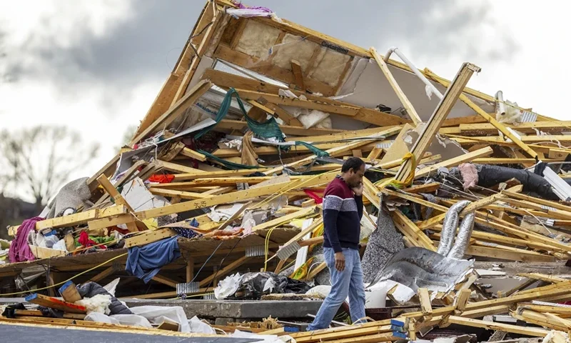 Gopala Penmetsa walks past his house after it was leveled by a tornado near Omaha, Neb., on Friday, April 26, 2024. (Chris Machian/Omaha World-Herald via AP)
